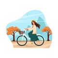 Girl in a hat and dress rides a bicycle, autumn landscape. Woman on a bicycle carries apples in a basket. Vector Royalty Free Stock Photo