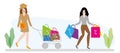 A girl in a hat and dress rolls a shopping basket and a second girl with shopping bags goes. Royalty Free Stock Photo