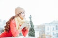 The girl in the hat froze and drinking hot tea Royalty Free Stock Photo