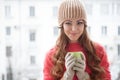 The girl in the hat froze and drinking hot tea Royalty Free Stock Photo