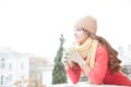 The girl in the hat froze and drinking hot tea Royalty Free Stock Photo