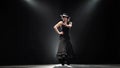 Girl dancing a Spanish incendiary dance. Black background. Llight from behind. Slow motion