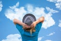 Girl in hat looks at dove birds in cloud shape soars in blue sky. Concept of love, romance and happy relations. Valentine day or