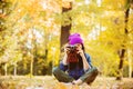 Girl in hat with professional camera on fall season park Royalty Free Stock Photo