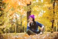 Girl in hat with professional camera on fall season park Royalty Free Stock Photo