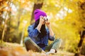 Girl in hat with professional camera on fall season park Royalty Free Stock Photo