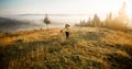 Girl with hat run with happiness on top of a mountain in autumn sunrise. Royalty Free Stock Photo