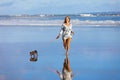 Girl have fun with dachshund dog, run by sea beach Royalty Free Stock Photo