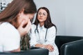 Girl have mental breakdown and crying. Young woman have a visit with female doctor in modern clinic Royalty Free Stock Photo