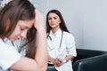 Girl have mental breakdown and crying. Young woman have a visit with female doctor in modern clinic Royalty Free Stock Photo