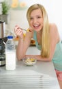 Girl having breakfast eating flakes with milk Royalty Free Stock Photo