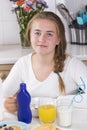 Girl having breakfast in kitchen