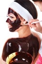 Girl having chocolate facial mask. Royalty Free Stock Photo