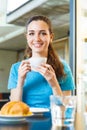 Girl having a coffee break with cappuccino Royalty Free Stock Photo