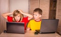 Girl having a computer problem. Cute children using laptops at h Royalty Free Stock Photo