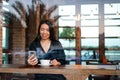 Girl having coffee and using phone in the bar Royalty Free Stock Photo