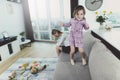 Girl Having Fun Jumping on Sofa when Mother Upset