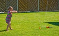 Girl having fun with sprinkler in garden