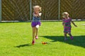 Girl having fun with sprinkler in garden Royalty Free Stock Photo