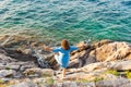 Girl having fun standing on the rocks near the sea Royalty Free Stock Photo