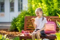 girl is having lunch sitting next to the school