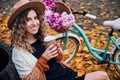 Girl having rest outdoors near bicycle at autumn. Royalty Free Stock Photo