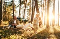 Girl is having a walk. Happy family of father, mother and little daughter is in the forest Royalty Free Stock Photo