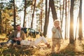 Girl is having a walk. Happy family of father, mother and little daughter is in the forest Royalty Free Stock Photo