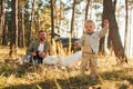 Girl is having a walk. Happy family of father, mother and little daughter is in the forest Royalty Free Stock Photo