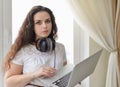 Girl with the head-phones working in a laptop Royalty Free Stock Photo