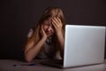 Girl with headache sitting at the desk and doing homework . Tired child using computer. Royalty Free Stock Photo