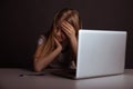 Girl with headache sitting at the desk and doing homework . Tired child using computer. Royalty Free Stock Photo