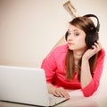 Girl with headphones and laptop listening to music Royalty Free Stock Photo