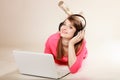 Girl with headphones and laptop listening to music Royalty Free Stock Photo