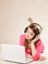 Girl with headphones and laptop listening to music Royalty Free Stock Photo