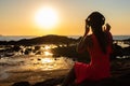 Girl in headphones listening to music in the city at sunset. Royalty Free Stock Photo