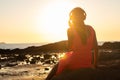 Girl in headphones listening to music in the city at sunset. Royalty Free Stock Photo