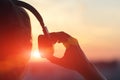 Girl in headphones listening to music in the city at sunset Royalty Free Stock Photo