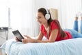 Girl in headphones listening to music on tablet pc Royalty Free Stock Photo