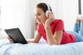 Girl in headphones listening to music on tablet pc Royalty Free Stock Photo
