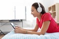 Girl in headphones listening to music on tablet pc Royalty Free Stock Photo