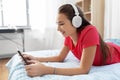 Girl in headphones listening to music on tablet pc Royalty Free Stock Photo