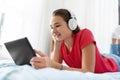 Girl in headphones listening to music on tablet pc Royalty Free Stock Photo