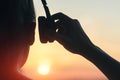 Girl in headphones listening to music in the city at sunset Royalty Free Stock Photo