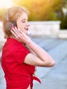 Girl in headphones listens to music in city Royalty Free Stock Photo