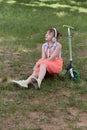A girl with headphones listens to music and enjoys the good weather. Royalty Free Stock Photo