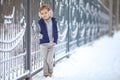 Girl in headphones near fence in winter in Park