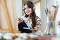 Girl in headphones paints with oil colors Royalty Free Stock Photo