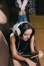 Girl with headphones watching movie on smart phone