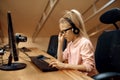 Girl in headphones works on PC, little blogger